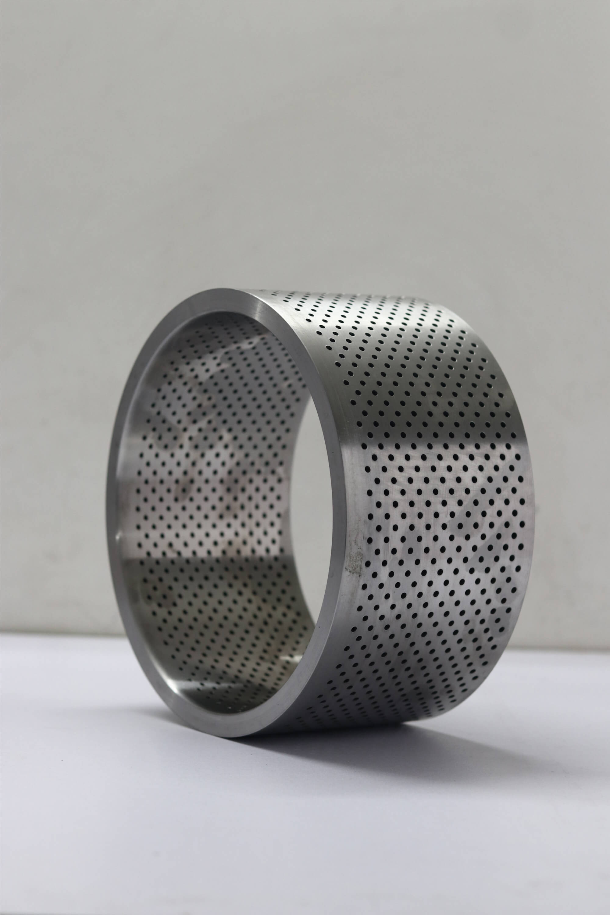 Perforated stainless steel cylindrical sleeve