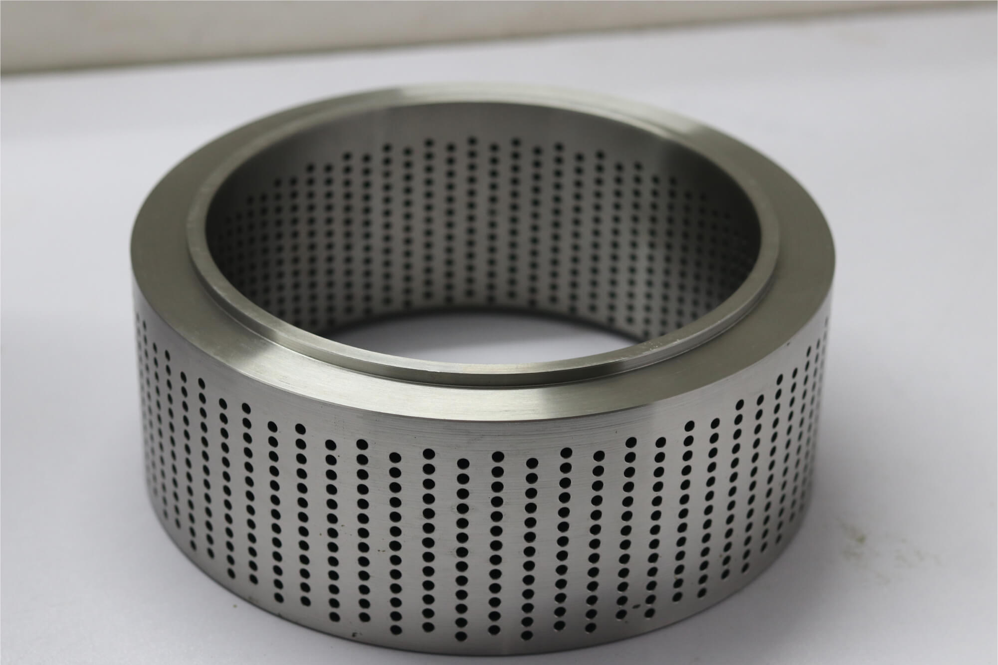 Perforated stainless steel cylindrical sleeve