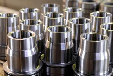 Machined flanged bushing components